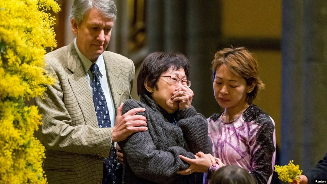 On Australia's national day of mourning for victims of downed Malaysia Airlines flight MH-17, a relative grieves during a service at St. Patrick’s Cathedral in Melbourne Aug. 7, 2014. 
