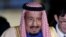 FILE - Saudi King Salman bin Abdulaziz al-Saud arrives at Haneda international airport in Tokyo, March 12, 2017. 