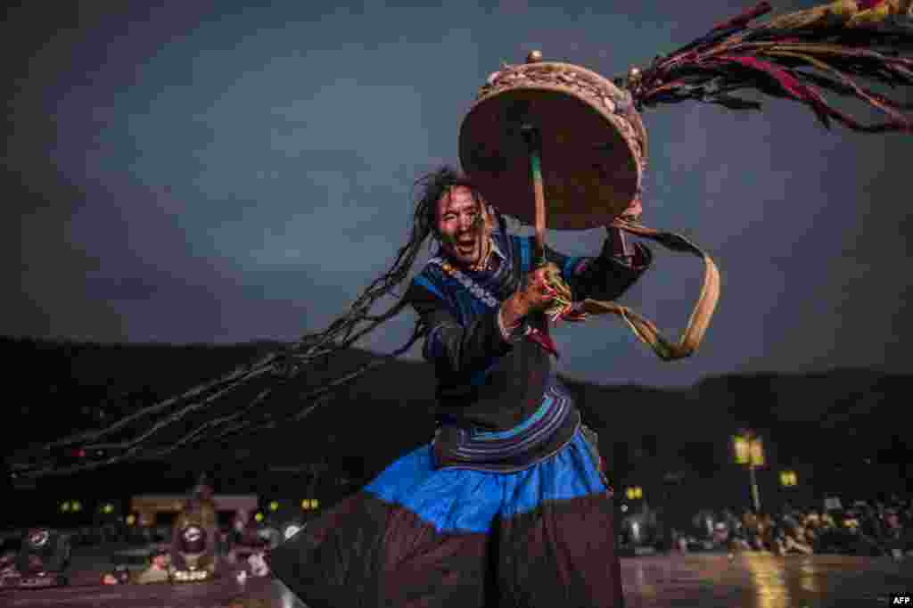 A shaman, dressed with the traditional Yi costume, performs at the Torch Festival, in Xichang, China&#39;s Sichuan province, July 27, 2016.