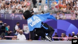 Refugee Team's Manizha Talash wears a cape that reads "Free Afghan Women" as she competes during a prequalifier battle in the breaking competition at the 2024 Summer Olympics on Aug. 9, 2024, in Paris.