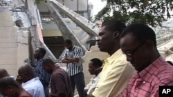 Catholics in Haiti attend mass outside after their church was heavily damaged in the recent earthquake.