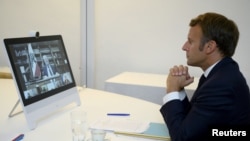 French President Emmanuel Macron participates in a donor teleconference with other world leaders concerning the situation in Lebanon following Tuesday's devastating blast in Beirut, in Fort de Bregancon in Bormes-les-Mimosas, France, Aug. 9, 2020.