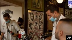 A barber gives a customer a haircut after coronavirus restrictions were eased, opening shopping centers, gyms, barber shops, among other sites in Jerusalem, Feb. 23, 2021.