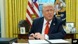 President Donald Trump speaks with reporters as he signs executive orders in the Oval Office at the White House, Feb. 10, 2025.