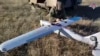 In this photo taken from video distributed by Russian Defense Ministry Press Service on Jan. 26, 2025, a Russian serviceman prepares a "Orlan-10" drone in an undisclosed location in Ukraine. 