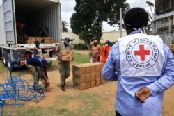 Guards from a prison unload an International Committee of the Red Cross truck containing sanitary kit amid the coronavirus disease outbreak in Dabou, Ivory Coast, April 16, 2020.