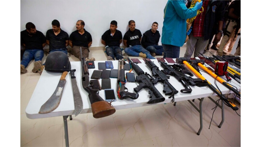 FILE - Suspects in the assassination of Haiti's President Jovenel Moise are shown to the media, along with the weapons and equipment they allegedly used in the attack, in Port-au-Prince, Haiti, July 8, 2021.