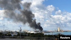 A smoke rises from a port of Tripoli after being attacked in Tripoli, Libya February 18, 2020. REUTERS/Ahmed Elumami