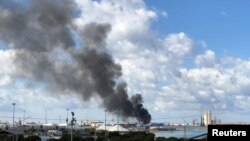 A smoke rises from a port after an attack in Tripoli, Libya, Feb. 18, 2020.