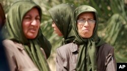 In this September 11, 2012 file photo, members of the Mujahedeen-e-Khalq organization are seen inside the Liberty refugee camp in Baghdad, Iraq. 