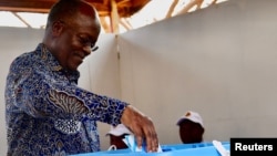 Tanzanian President John Pombe Magufuli casts his ballot during the Presidential and Parliamentary elections in Chamwino district in Dodoma, Tanzania Oct. 28, 2020.