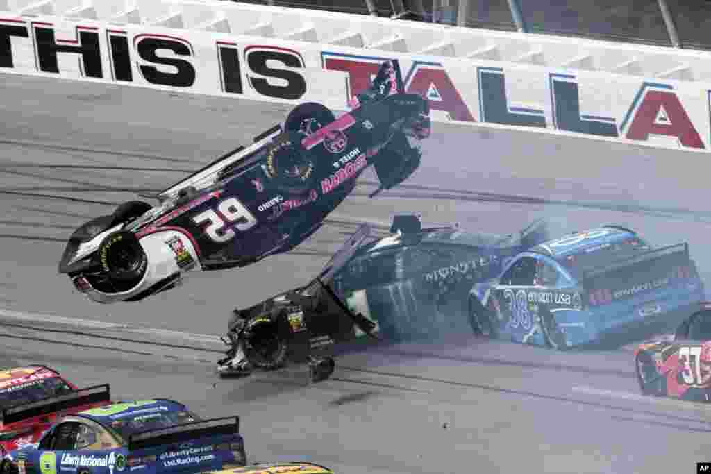 Brendan Gaughan (62) flips in Turn 3 as driver Kurt Busch (1) and David Ragan (38) pass underneath during a NASCAR Cup Series auto race at Talladega Superspeedway, Oct 14, 2019, in Talladega, Alabama.