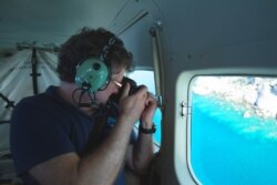 Professor Terry Hughes conducts an aerial survey of coral bleaching on the Great Barrier Reef, in this photo received April 6, 2020, from the ARC Centre of Excellence for Coral Reef Studies at James Cook University.