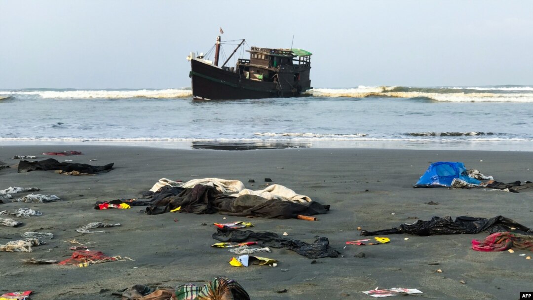 Belongings of Rohingya refugees lay on the shore as their carrier boat remains anchored nearby in Teknaf, Bangladesh. Thirty-two Rohingya died on an overcrowded fishing trawler stranded in the Bay of Bengal for nearly two months, officials said.