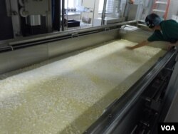 Sister Maria Gonzalo-Garcia checks the curds during the cheese-making process. (VOA/J. Taboh)