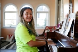 Grace Brown, 14, poses for a portrait by the piano at her home in Alexandria, Va., Friday, Nov. 1, 2019.