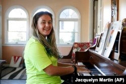 Grace Brown, 14, poses for a portrait by the piano at her home in Alexandria, Va., Friday, Nov. 1, 2019.