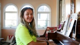 Grace Brown, 14, poses for a portrait by the piano at her home in Alexandria, Va., Friday, Nov. 1, 2019.