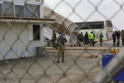 Police patrol the airport upon the arrival of Zimbabwean Nationals deported from the United Kingdom, at Robert Mugabe International airport in Harare, Thursday, July 22, 2021. (AP)