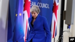 British Prime Minister Theresa May leaves the podium after addressing a media conference at the conclusion of an EU summit in Brussels, April 11, 2019.