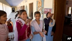 Girls take deworming pills in their school in Neemrana, 123 kilometers (76.8 miles) from New Delhi, in the Indian state of Rajasthan, Feb. 10, 2016. Millions of Indian children are taking part in a massive national deworming campaign to prevent parasitic worms from infecting their bodies and impairing their mental and physical development. 