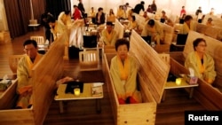 Participants sit inside coffins during a "living funeral" event as part of a "dying well" programme, in Seoul, South Korea, October 31, 2019. 