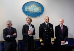 FILE - From left, members of the U.S. coronavirus task force Dr. Anthony Fauci, Dr. Deborah Birx, Jerome Adams, and Dr. Stephen Hahn arrive to attend a coronavirus briefing at the White House, in Washington, April 10, 2020.