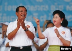 Cambodia's Prime Minister and president of the ruling Cambodian People's Party Hun Sen and his wife Bun Rany attend an election campaign in Phnom Penh, Cambodia, July 7, 2018.