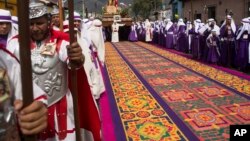 FILE - A street decoration made from dyed sawdust lays intact before a Good Friday procession walks over it during Holy Week in Antigua, Guatemala, Apr. 3, 2015. 