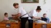 Professional nurse Laura Murphy (R) and volunteer Loretta Gaughan from Ireland feed children at an orphanage for mentally disabled children under the Vesnova institution, near the Belarussian village of Vesnova, June 6, 2013.