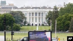 IMAGE DISTRIBUTED FOR AVAAZ - A moving billboard with an image of President Trump as Pinocchio circles the White House May 28, 2020, in Washington, D.C. 