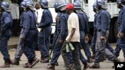 Zimbabwean police arrest an MDC supporter in Harare recently … Activists say ongoing political unrest in Zimbabwe makes it dangerous for migrants in South Africa to return to their homeland