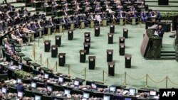 Iranian President Masoud Pezeshkian addresses parliament during a session to approve his cabinet appointments, in Tehran on Aug. 21, 2024.