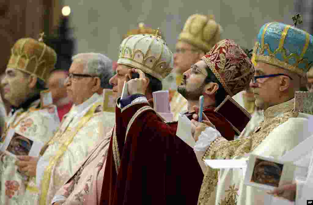 Para uskup mengambil foto ketika Paus Fransiskus memimpin misa untuk memperingati 100 tahun pembunuhan massal warga Armenia yang dianggap genosida, di Basilika Santo Petrus, Vatikan.