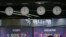 A currency trader works near the screens showing the KOSPI left, and the foreign exchange rate between U.S. dollar and South Korean won at the foreign exchange dealing room in Seoul, South Korea, May 18, 2020.