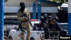 Haitian soldiers guard the entrance of the General Directorate of the police where the suspects of the assassination of President Jovenel Moise are detained, in Port-au-Prince, July 10, 2021.