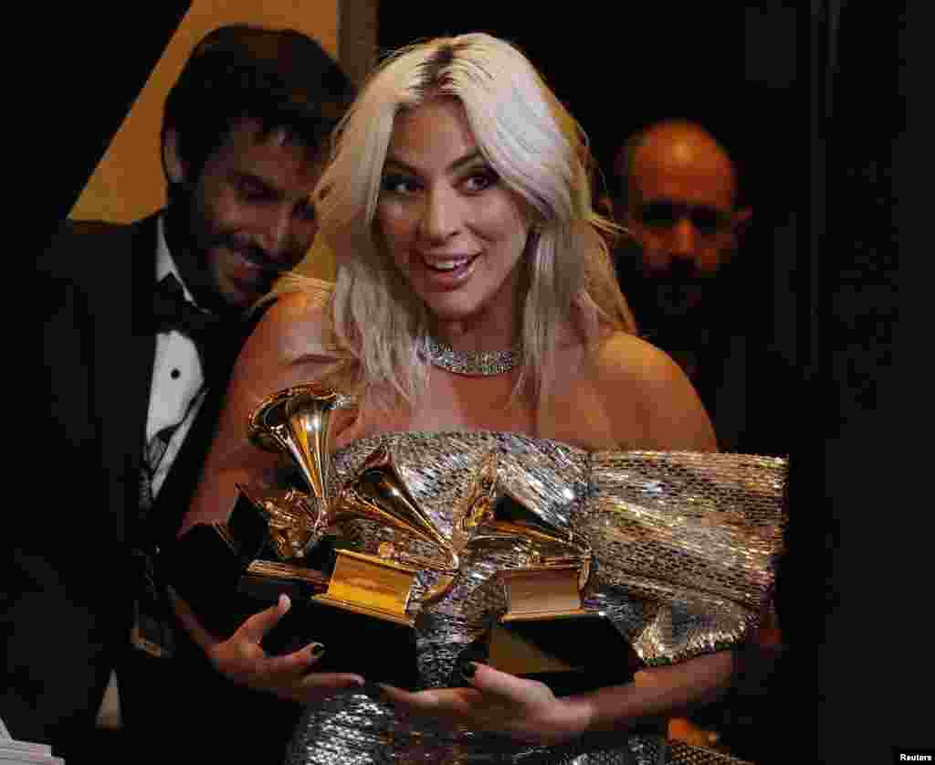 Lady Gaga poses backstage with her awards for Best Song Written for Visual Media and Best Pop Duo/Group Performance for &quot;Shallow&quot; and her Best Pop Solo Performance for &quot;Joanne (Where do You Think You&#39;re Goin?)&quot; during the 61st Grammy Awards in Los Angeles, California, Feb. 10, 2019.