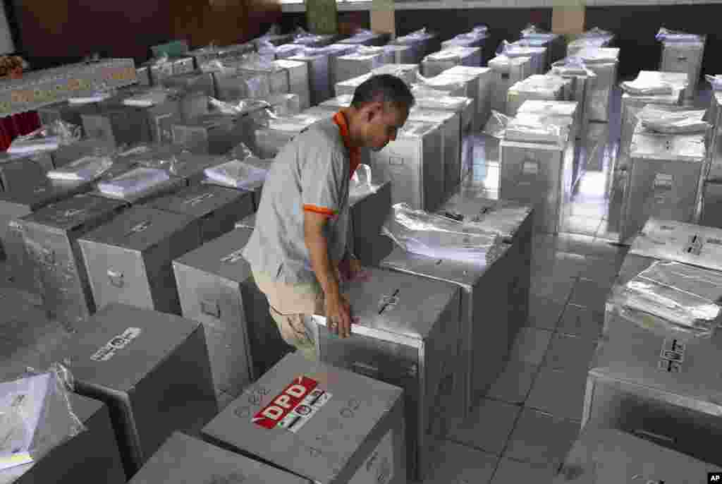 An election official arranges ballot boxes to be distributed to polling stations at a local government office in Jakarta, April 8, 2014.