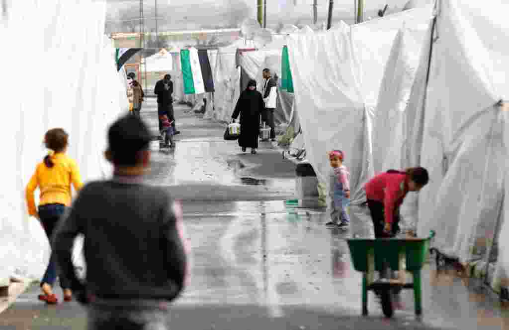 Syrian refugees at their tents at the Boynuyogun refugee camp on the Turkish-Syrian border. There are 1,750 Syrian refugees living at the camp. (Reuters)