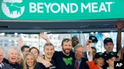 Ethan Brown, center, CEO of Beyond Meat, attends the Opening Bell ceremony with guests to celebrate the company's IPO at Nasdaq, Thursday, May 2, 2019 in New York. 