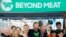 Ethan Brown, center, CEO of Beyond Meat, attends the Opening Bell ceremony with guests to celebrate the company's IPO at Nasdaq, Thursday, May 2, 2019 in New York. California-based Beyond Meat makes burgers and sausages out of pea protein and other ingredients.