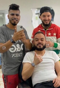 Amjed Bin Mahmoud, left, lost his friend Tariq, seated, over the weekend in one of 138 deaths from bombs left in homes and neighborhoods since late May, in Tripoli, Libya, pictured Dec. 29, 2019. (Photo courtesy of Amjed Bin Mahmoud)