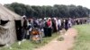 People queue to vote in a referendum at a polling station in Harare, March 16, 2013. 