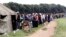 People queue to vote in a referendum at a polling station in Harare, March 16, 2013. 