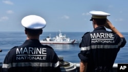 FILE - French navy officers aboard frigate FS Prairial salute at the Philippine coast guard vessel BRP Capones during a passing exercise at the waters of South China Sea on March 20, 2023. (ALPACI - France Pacific Command via AP)