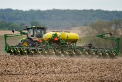 FILE - A farmer plants soybeans in a field in Springfield, Neb., May 23, 2019.