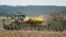 FILE - A farmer plants soybeans in a field in Springfield, Neb., May 23, 2019. 