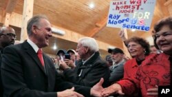 U.S. Senate candidate Roy Moore greets supporters before speaking at a campaign rally, Dec. 11, 2017, in Midland City, Ala. 