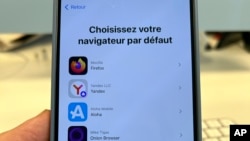 A pop-up message to choose a browser is displayed on the screen of an iPhone, in Brussels, Belgium, March 6, 2024. Europeans this week will get new choices for default browsers and search engines.