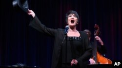 Tiffany Utterson, right, and her children, from left to right, Ella, 11, Ian, 10 and Owen, 8, place a wreath outside the gated community entrance to the home of former President George H.W. Bush in Houston, Texas. Bush died late Friday at his Houston home at age 94.